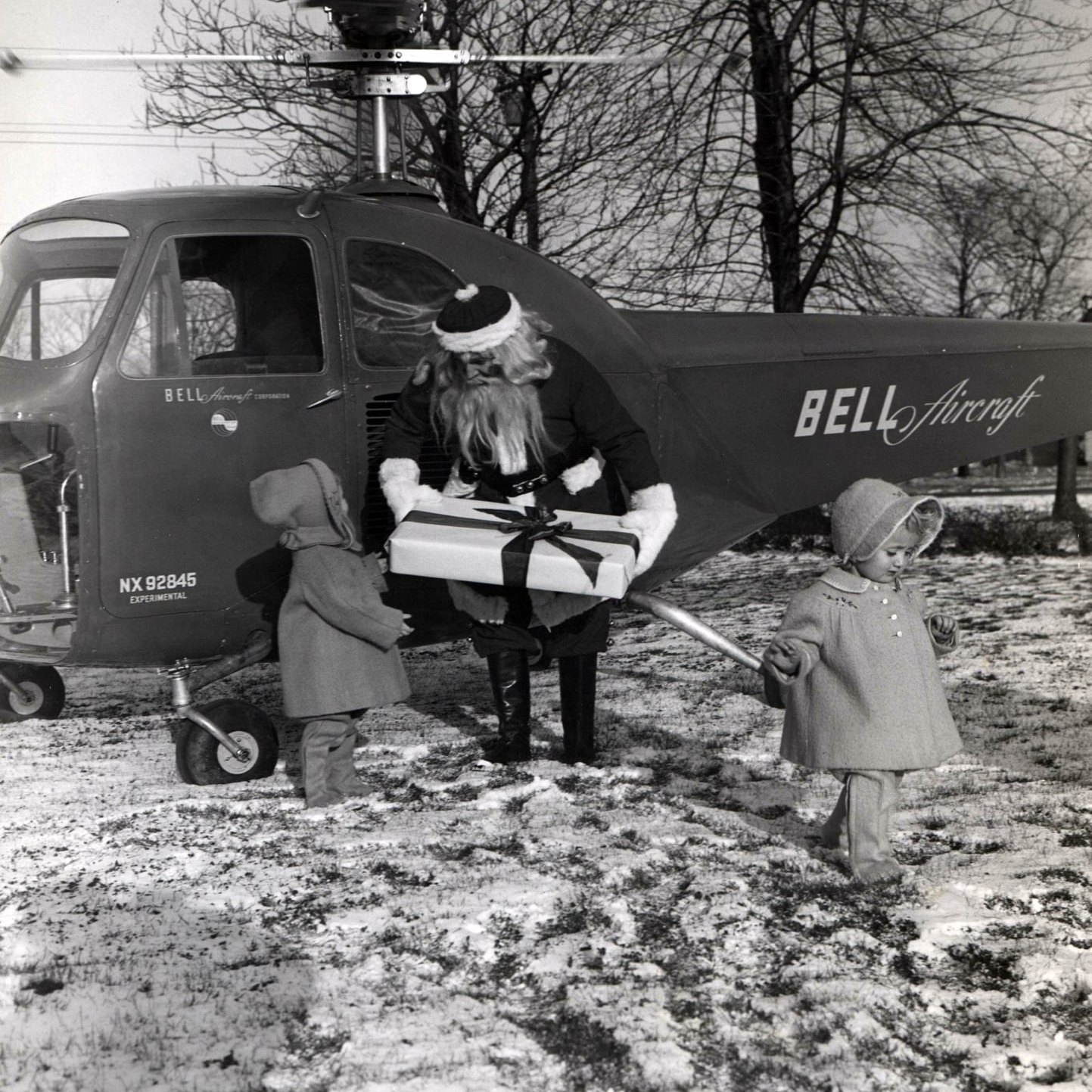 Historic helicopter delivering Christmas presents to the Aero Club of Buffalo